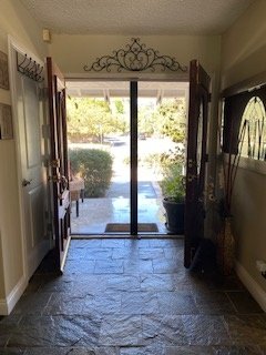 Entry foyer with slate tile flooring and decorative iron archway
