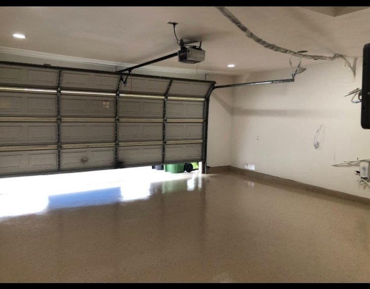 Spacious two-car garage with epoxy floor and recessed lighting