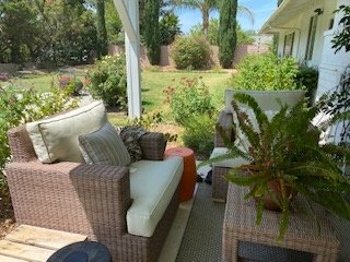 Lounge chairs on patio overlooking the garden and front yard