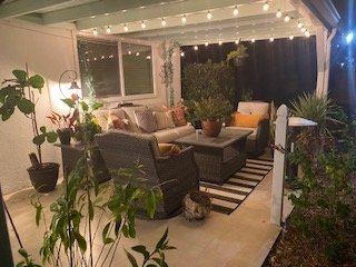 Covered patio glowing with warm string lights at night